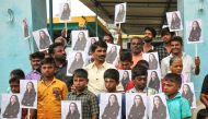 People holding placards with the photo of Vice President-elect Kamala Harris celebrate on the day of her inauguration in the village of Thulasendrapuram, where Harris' maternal grandfather was born and grew up, in the southern Indian state of Tamil Nadu, 