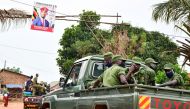 Ugandan security officers ride on their pickup truck as they patrol an area near the house of the presidential candidate and singer Robert Kyagulanyi Ssentamu, known as Bobi Wine in Magere neighbourhood of Kampala, Uganda January 16, 2021. REUTERS/Abubake