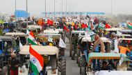 FILE PHOTO: Farmers participate in a tractor rally to protest against the newly passed farm bills, on a highway on the outskirts of New Delhi, India, January 7, 2021. REUTERS/Adnan Abidi/File Photo
