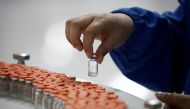 A worker performs a quality check in the packaging facility of Chinese vaccine maker Sinovac Biotech, developing an experimental coronavirus disease (COVID-19) vaccine, during a government-organized media tour in Beijing, China, September 24, 2020. REUTER