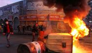Garbage bins, set on fire by demonstrators, block a road during a protest against the lockdown and worsening economic conditions, amid the spread of the coronavirus disease (COVID-19), in Tripoli, Lebanon January 26, 2021. REUTERS/Omar Ibrahim
