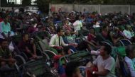 Tricycle drivers attend an outdoor movie screening held by a non-governmental organization (NGO). Reuters/Cindy Liu
