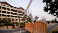 A security member keeps watch at a cordoned-off section of a hotel where members of the World Health Organisation (WHO) team tasked with investigating the origins of the coronavirus disease (COVID-19) went after leaving their quarantine hotel, in Wuhan, H