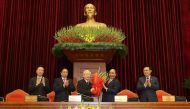 Vietnam's President and General Secretary of the Communist Party Nguyen Phu Trong (3rd L) receives flowers from Prime Minister Nguyen Xuan Phuc after he was re-selected as party chief for a 3rd term in Hanoi, Vietnam January 31, 2021. L-R are politburo me