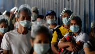 People wearing face masks as protection against the coronavirus disease (COVID-19) queue outside a government office, in Caloocan City, Metro Manila, Philippines, February 1, 2021. REUTERS/Lisa Marie David