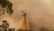 A helicopter flies overhead as its crew battles the Wooroloo Bushfire, northwest of Perth, Australia, February 2, 2021. Picture taken February 2, 2021. AAP Image/Supplied by Department of Fire And Emergency Services, Evan Collis/via REUTERS