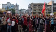 People show the three-finger salute as they rally in a protest against the military coup and to demand the release of elected leader Aung San Suu Kyi, in Yangon, Myanmar, February 7, 2021. REUTERS/Stringer