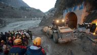 Members of Indo-Tibetan Border Police (ITBP) watch as a machine is used to clear a tunnel after a part of a glacier broke away, in Tapovan in the northern state of Uttarakhand, India, February 8, 2021. REUTERS/Stringer