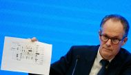 Peter Ben Embarek, a member of the World Health Organization (WHO) team tasked with investigating the origins of the coronavirus disease (COVID-19), holds a chart during the WHO-China joint study news conference at a hotel in Wuhan, Hubei province, China 