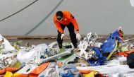 A member of Indonesia's rescue personnel observes the debris of Sriwijaya Air flight SJ 182, which crashed into the Java Sea, at the last day of the search and rescue operation, at Tanjung Priok port in Jakarta, Indonesia January 21, 2021. REUTERS/Ajeng D