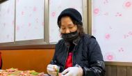 Lee Soon-ai, owner of a Korean traditional pancake house for over 15 years, puts meat onto skewers to sell for the Lunar New Year, in Seoul, South Korea February 11, 2021. REUTERS/Minwoo Park