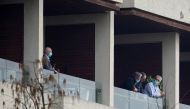 Dominic Dwyer, a member of the World Health Organisation (WHO) team tasked with investigating the origins of the coronavirus disease (COVID-19), stands on the balcony of a hotel in Wuhan, Hubei province, China February 8, 2021. REUTERS/Aly Song