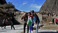 People help an injured woman to board a helicopter after a flash flood swept a mountain valley destroying dams and bridges, at Lata village in Chamoli district, in the northern state of Uttarakhand, India, February 12, 2021. Reuters/Anushree Fadnavis 