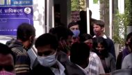 Climate change activist Disha Ravi is escorted by police officials as she walks out of the court in New Delhi, India February 14, 2021 in this still image taken from video. ANI via Reuters TV 
