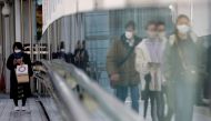 Pedestrians wearing protective masks amid the coronavirus disease (COVID-19) outbreak, make their way in Tokyo, Japan, February 2, 2021. REUTERS/Kim Kyung-Hoon/File Photo