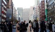 Pedestrians wearing protective masks, following the coronavirus disease (COVID-19) outbreak, make their way during commuting hour at a business district in Tokyo, Japan, January 7, 2021. REUTERS/Kim Kyung-Hoon/File Photo