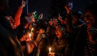 Supporters of a faction of the ruling Nepal Communist Party sing and dance as they hold candles after Nepal's top court ordered the reinstatement of the nation's parliament, in Kathmandu, Nepal February 23, 2021. REUTERS/Navesh Chitrakar
