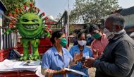 Volunteers distribute pamphlets during an awareness campaign on the spread of the coronavirus disease (COVID-19) on a street in Mumbai, India, February 22, 2021. REUTERS/Niharika Kulkarni

