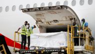 Workers offload boxes of AstraZeneca/Oxford vaccines as the country receives its first batch of coronavirus disease (COVID-19) vaccines under COVAX scheme, at the international airtport of Accra, Ghana February 24, 2021. Reuters/Francis Kokoroko