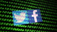 FILE PHOTO: The Twitter and Facebook logo along with binary cyber codes are seen in this illustration taken November 26, 2019. REUTERS/Dado Ruvic/Illustration
