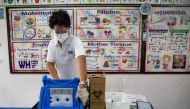 A health worker opens a box containing mock COVID-19 vaccines during a simulation in preparation for its arrival, at an elementary school turned vaccination command center in Pasig City, Metro Manila, Philippines, February 16, 2021. REUTERS/Eloisa Lopez/F