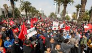 Supporters of Tunisia's biggest political party, the moderate Islamist Ennahda, march during a rally in opposition to President Kais Saied, in Tunis, Tunisia February 27, 2021. REUTERS/Zoubeir Souissi