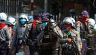 A riot police officer fires a rubber bullet toward protesters during a protest against the military coup in Yangon, Myanmar, February 28, 2021. REUTERS/Stringer