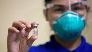A health worker holds a vial of Sinovac Biotech's Coronavac vaccine on the first day of the coronavirus disease (COVID-19) inoculation drive in the Philippines, at the Lung Center of the Philippines, Quezon City, Metro Manila, March 1, 2021. REUTERS/Elois