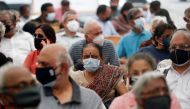 FILE PHOTO: People wait to receive a dose of COVISHIELD, a COVID-19 vaccine manufactured by Serum Institute of India, in Mumbai, India, March 1, 2021. REUTERS/Francis Mascarenhas/File Photo
