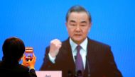Chinese State Councillor and Foreign Minister Wang Yi is displayed on a screen as he attends via video link a news conference on the sidelines of the National People's Congress (NPC), in Beijing, China March 7, 2021. REUTERS/Thomas Peter