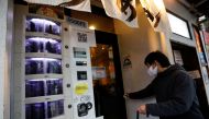 A vending machine selling a polymerase chain reaction (PCR) test for the coronavirus disease (COVID-19), operated by Takenoko ENT Clinic, is installed at the entrance of a ramen noodle shop at Shibuya district in Tokyo, Japan March 8, 2021. REUTERS/Issei 