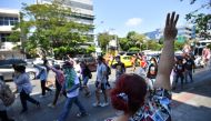 Anti-government demonstrators flash the three-finger salute during a march from Kasetsart University towards Democracy monument, in Bangkok, Thailand, March 7, 2021. REUTERS/Chalinee Thirasupa