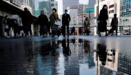 Pedestrians wearing protective masks amid the coronavirus disease (COVID-19) outbreak, make their way in Tokyo, Japan, February 2, 2021. REUTERS/Kim Kyung-Hoon/File Photo