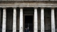 People walk in the street as the government is due to announce stricter coronavirus disease (COVID-19) restrictions, in Rome, Italy, March 12, 2021. REUTERS/Yara Nardi