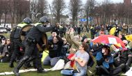 Police clash with demonstrators during a protest against coronavirus disease (COVID-19) restrictions in THE HAGUE, Netherlands, March 14, 2021. REUTERS/Piroschka Van De Wouw
