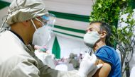  A man reacts while receiving his first dose of China's Sinovac Biotech vaccine for the coronavirus disease (COVID-19) during the mass vaccination program for elderly people at Indonesia's health ministry in Jakarta, Indonesia, March 2, 2021. REUTERS/Ajen