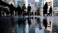 Pedestrians wearing protective masks amid the coronavirus disease (COVID-19) outbreak, make their way in Tokyo, Japan, February 2, 2021. REUTERS/Kim Kyung-Hoon/File Photo