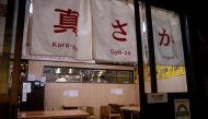 Vegan izakaya restaurant Masaka's manager Yuta Namekawa works in the kitchen as the restaurant is empty during the dinner hour in Tokyo, Japan, March 2, 2021. Picture taken March 2, 2021. REUTERS/Kim Kyung-Hoon
