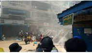 FILE PHOTO: Protesters cover behind a makeshift barricade facing police in Hlaing Township, Yangon, Myanmar March 17, 2021, in this still image from a social media video obtained by Reuters