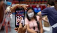 A healthcare worker documents his colleague getting inoculated with a coronavirus disease (COVID-19) vaccine at San Juan City, Metro Manila, Philippines, March 23, 2021. REUTERS/Eloisa Lopez
