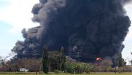 Smoke rises during a fire at Pertamina's oil refinery in Balongan, Indramayu regency, West Java province, Indonesia, March 29, 2021 in this photo taken by Antara Foto. Antara Foto/Dedhez Anggara/ via Reuters 