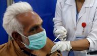 FILE PHOTO: An elderly resident receives the first dose of the coronavirus disease (COVID-19) vaccine, as the government started vaccination for the general public, starting with elderly people, at a vaccination center in Karachi, Pakistan March 10, 2021.