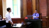 Vietnam Airlines flight attendant Duong Tan Hau, attends court before being found guilty of violating COVID-19 quarantine rules and handed a two year suspended prison term in Ho Chi Minh City, Vietnam March 30, 2021. VNA via REUTERS