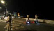 Police officers patrol on Segways along the promenade at Marine Drive during a curfew to limit the spread of the coronavirus disease (COVID-19), in Mumbai, India, March 29, 2021. REUTERS/Niharika Kulkarni
