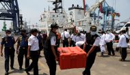 Indonesia's National Transportation Safety Committee (KNKT) officials carry a safety box containing the Cockpit Voice Recorder (CVR) of Sriwijaya Air flight SJ 182, at Tanjung Priok Port in Jakarta, Indonesia, March 31, 2021. REUTERS/Willy Kurniawan