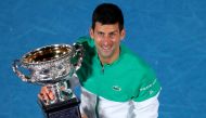 Serbia's Novak Djokovic celebrates with the trophy after winning his final match against Russia's Daniil Medvedev REUTERS/Kelly Defina/File Photo