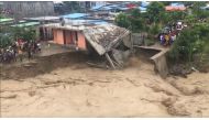 A house collapses after its foundations were washed away as the Comoro River is flooded in Dili, East Timor April 4, 2021, in this still image obtained from a social media video. Courtesy of Janito DF Afonso/Social Media via REUTERS