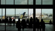 People look at a Singapore Airlines plane, amid the spread of the coronavirus disease (COVID-19), at a viewing gallery of the Changi Airport in Singapore October 12, 2020. Reuters/Edgar Su/File Photo