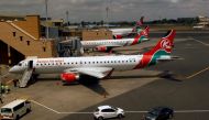 FILE PHOTO: Kenya Airways planes are seen through a window as the Jomo Kenyatta international airport reopens after flights were suspended following the coronavirus disease (COVID-19) outbreak in Nairobi, Kenya August 1, 2020. REUTERS/Njeri Mwangi/File Ph
