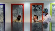 A healthcare worker wearing a protective face mask collects a swab sample from a man, amidst the spread of the coronavirus disease (COVID-19), in New Delhi, India, April 6, 2021. REUTERS/Anushree Fadnavis